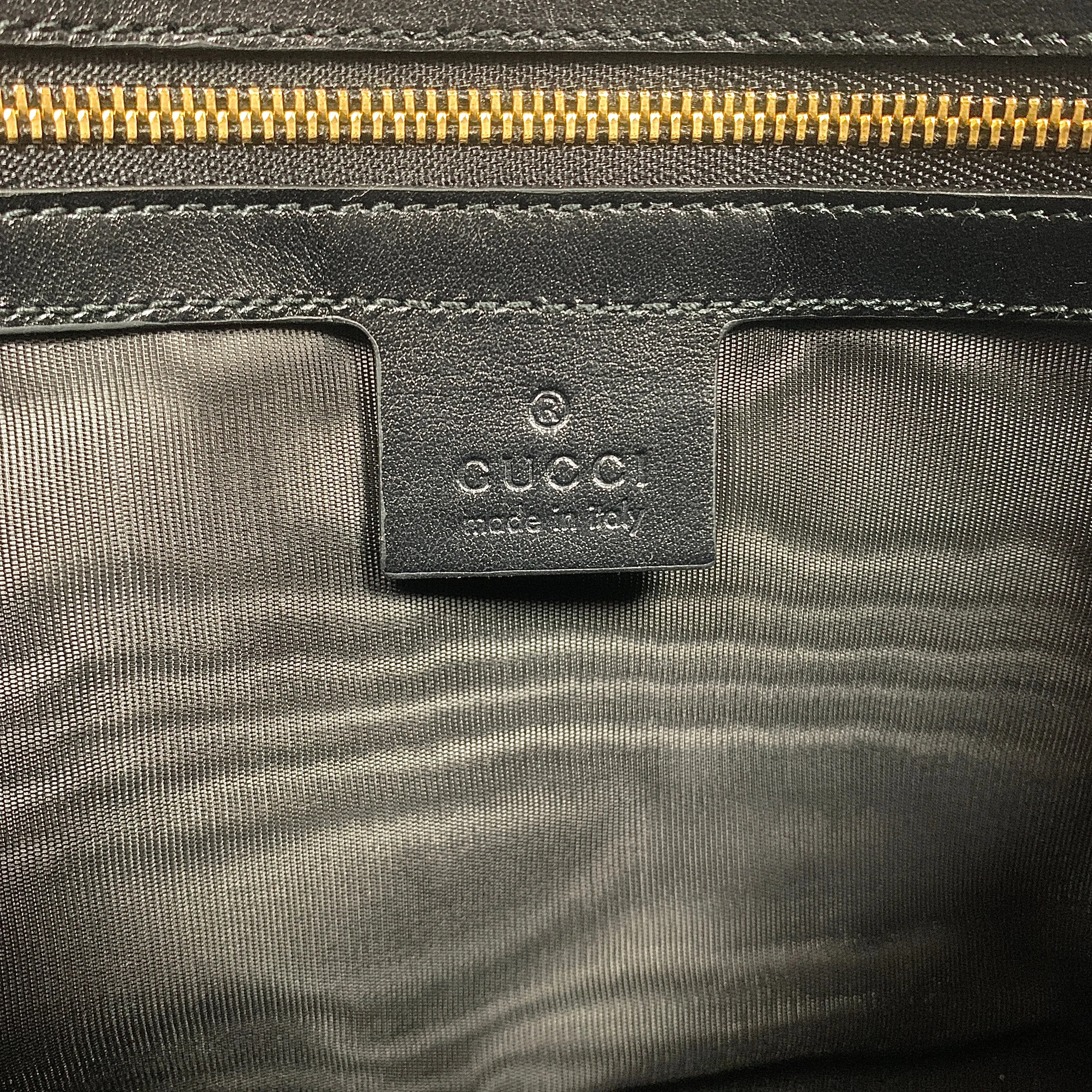 Gucci Metallic Print Logo Smooth Leather Clutch in Black