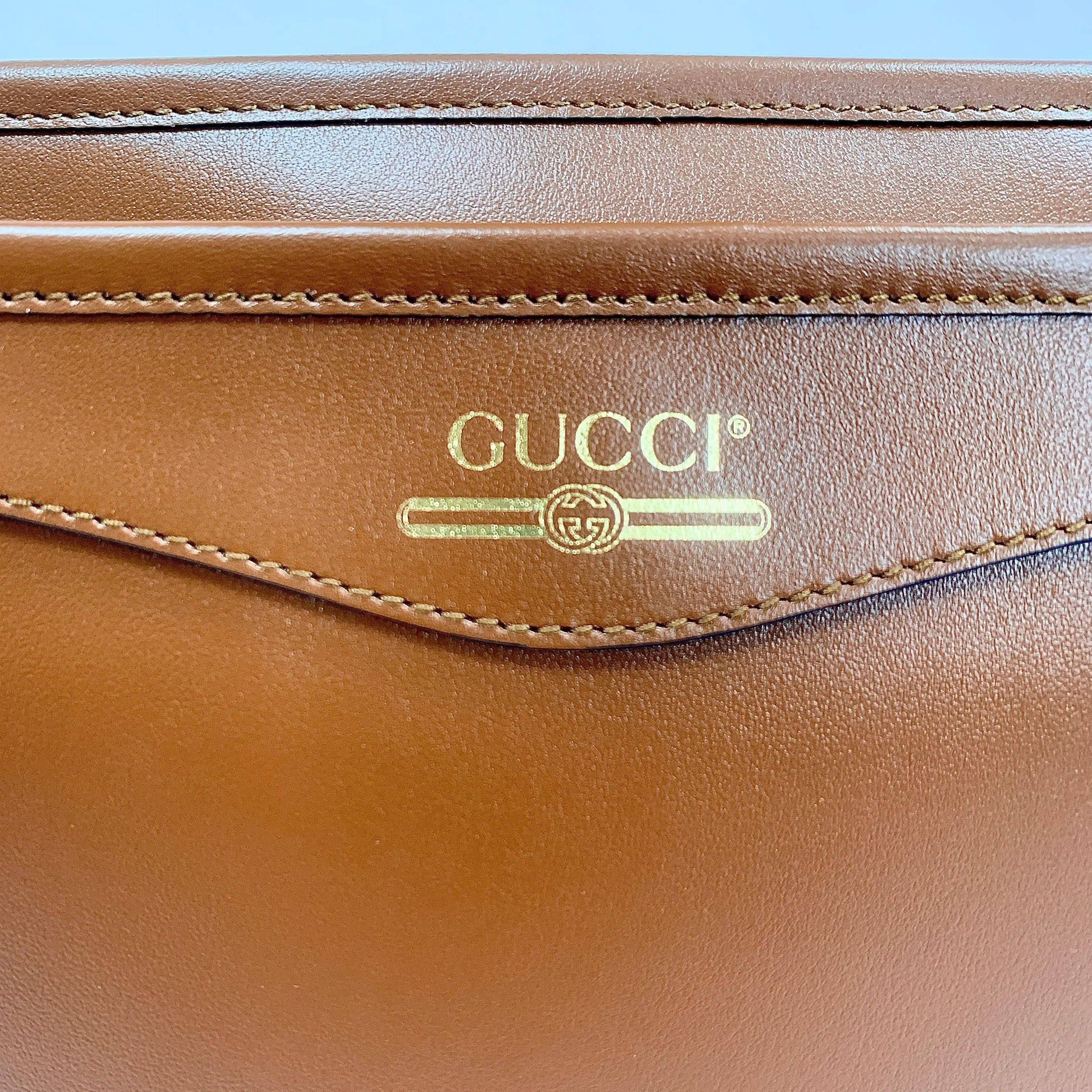 Gucci Metallic Print Logo Smooth Leather Clutch in Brown